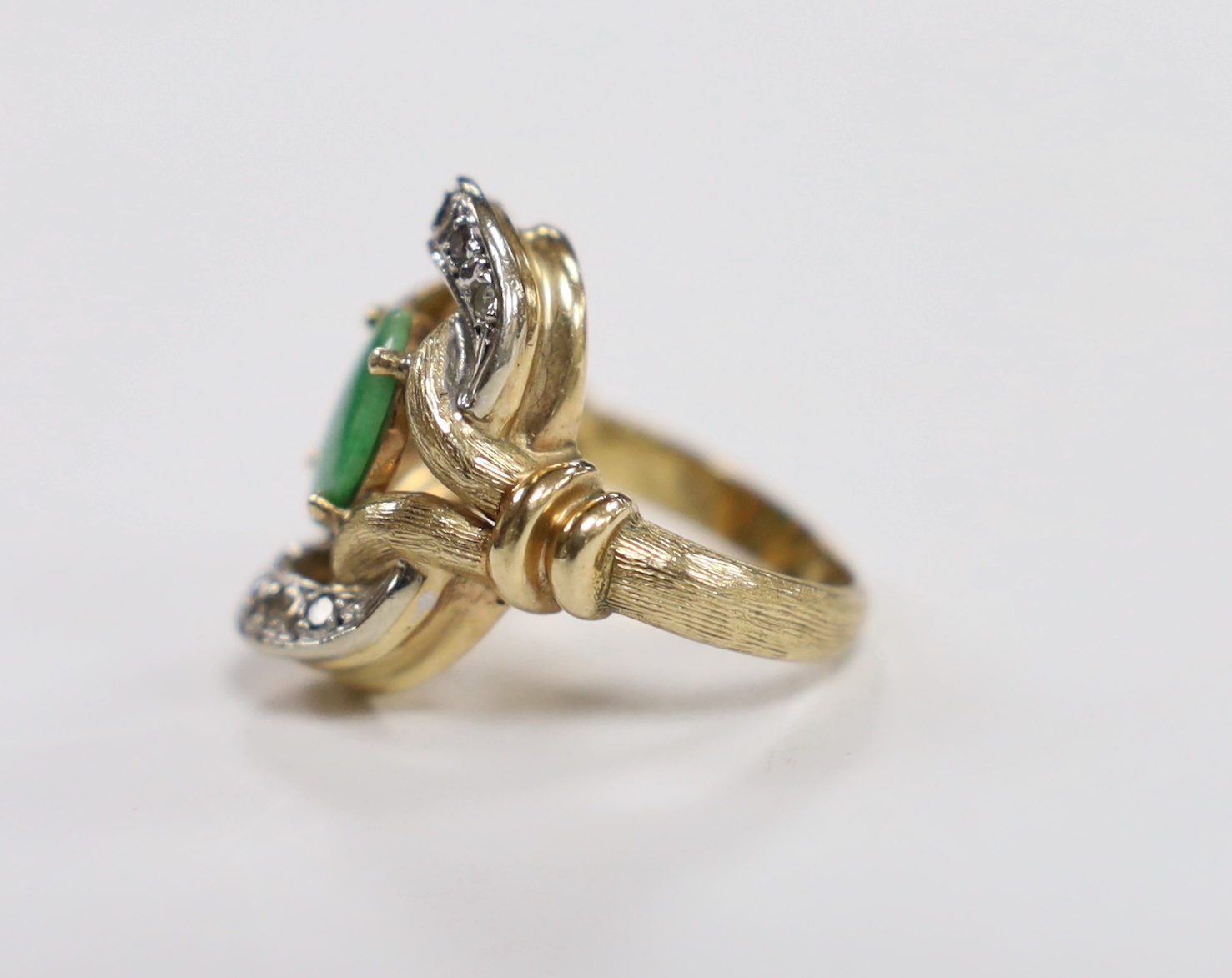 A 14k, oval cabochon jade and diamond cluster set dress ring, size J, gross weight 11.4 grams.